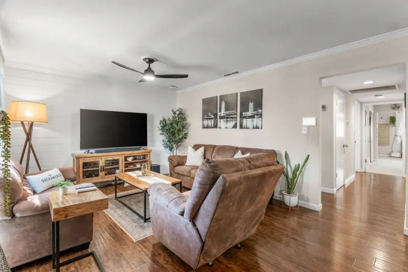 Living room with television, two sofas, and two recliners arranged for conversation
